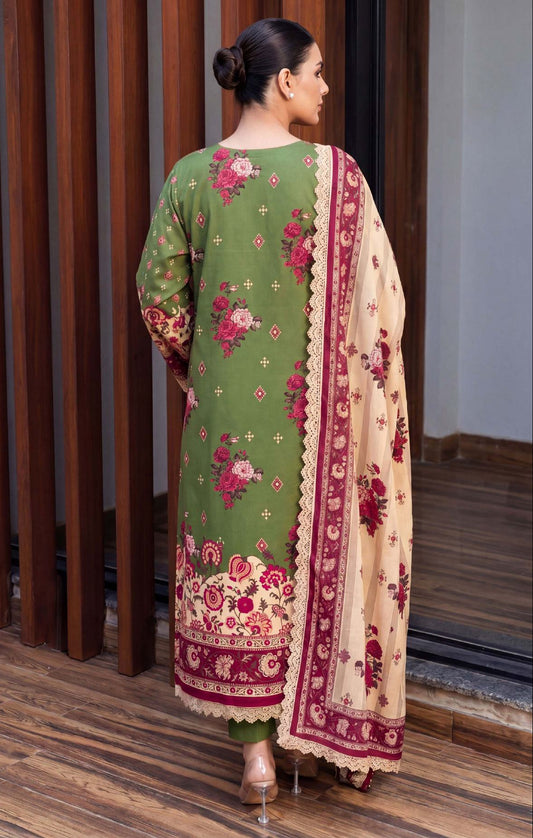 Woman wearing a green and beige traditional outfit with floral patterns indoors.